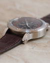 Macro photograph highlighting the polished lugs and screw construction of the stainless steel case.