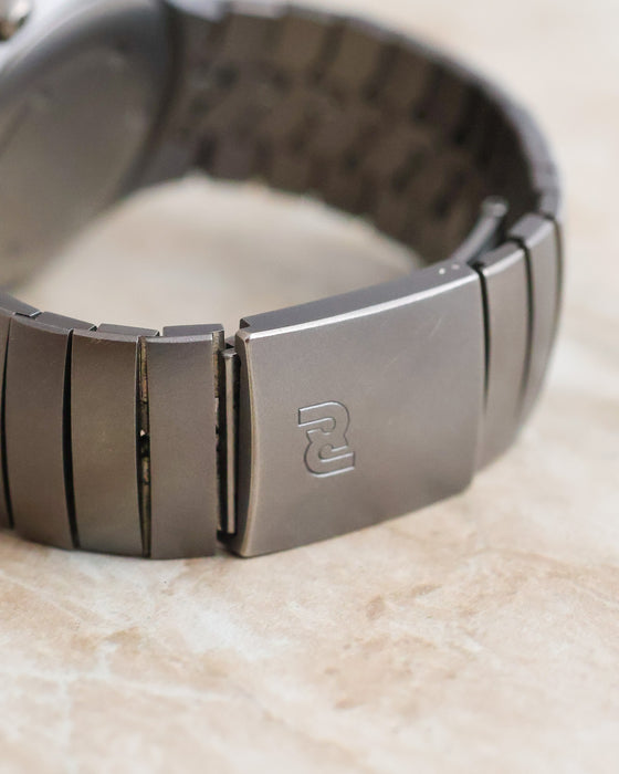 Close-up of the titanium folding clasp on the Porsche Design by IWC Ocean 500, showing the engraved Porsche Design logo.