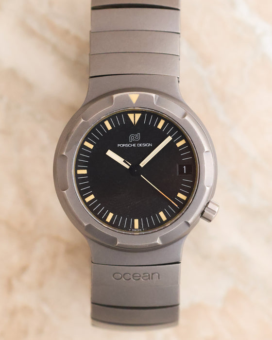 Front view of the 1985 Porsche Design Ocean 500 Ref. 3502 with black dial, tritium markers, titanium case and integrated bracelet.