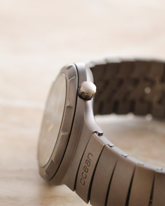Side profile of the Porsche Design Ocean 500 showing the crown, titanium case and Ocean-engraved bracelet link.