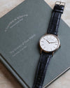 A. Lange & Söhne Saxonia Thin 201.027 in white gold with black leather strap, displayed on its guarantee and service booklet.