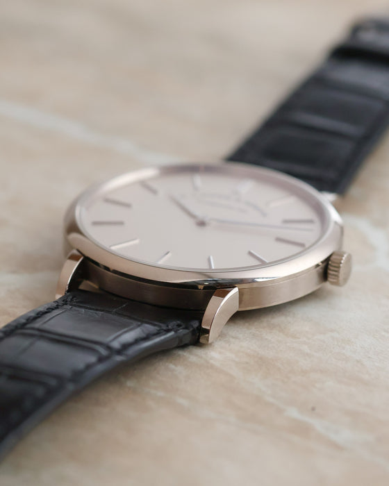 Side profile showing the slim white gold case, polished bezel and shaped lugs.