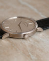 Close-up of the signed winding crown and brushed caseband on the Saxonia Thin.
