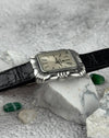 Side view of Universal Genève Flower Cushion watch showing stainless steel case thickness and leather strap