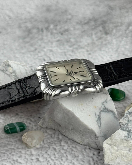 Side view of Universal Genève Flower Cushion watch showing stainless steel case thickness and leather strap