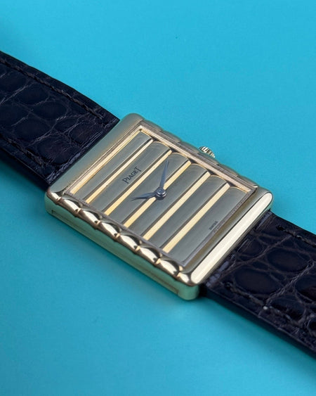 Close-up of Piaget 91480 dial featuring vertically ribbed 18K gold texture and matching gold baton hands
