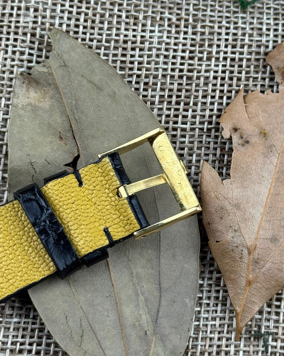 Close-up of Piaget-signed gold buckle on black leather strap, part of Ref. 9152 vintage dress watch