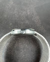 Side view of Girard-Perregaux opal dial watch showing steel crown and curved case profile