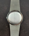 Case back of Girard-Perregaux 1990s watch in stainless steel with integrated bracelet and manual movement