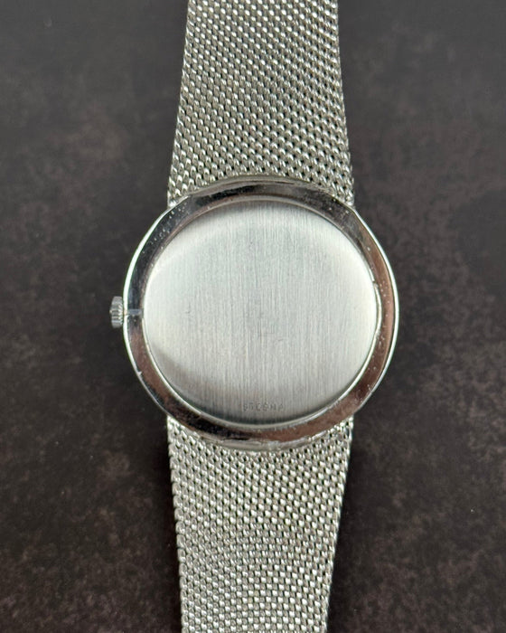 Case back of Girard-Perregaux 1990s watch in stainless steel with integrated bracelet and manual movement