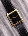 Front view of the vintage Piaget 9251 watch in 18K yellow gold, featuring a black onyx dial with diamond markers at 3, 6, 9, and 12 o’clock.