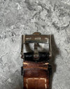 Original Rolex 18K white gold buckle attached to leather strap, signed with Rolex coronet logo