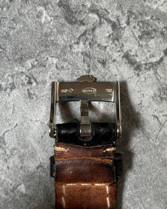 Original Rolex 18K white gold buckle attached to leather strap, signed with Rolex coronet logo