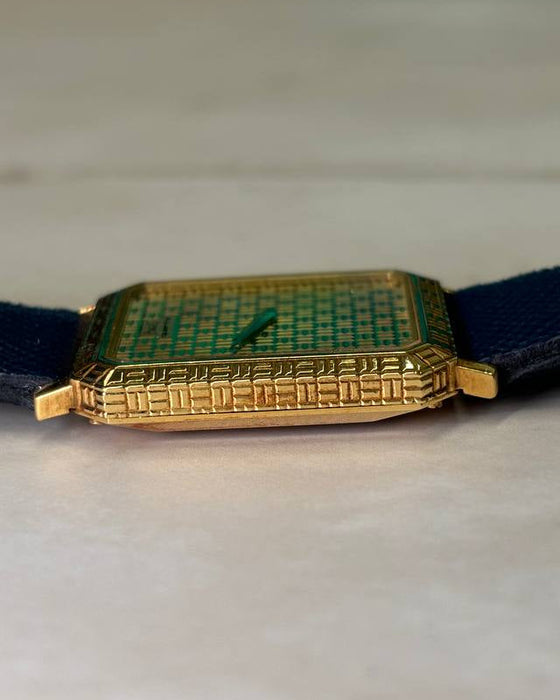 Side profile of Piaget 7143 watch showcasing slim 18K yellow gold case and integrated design